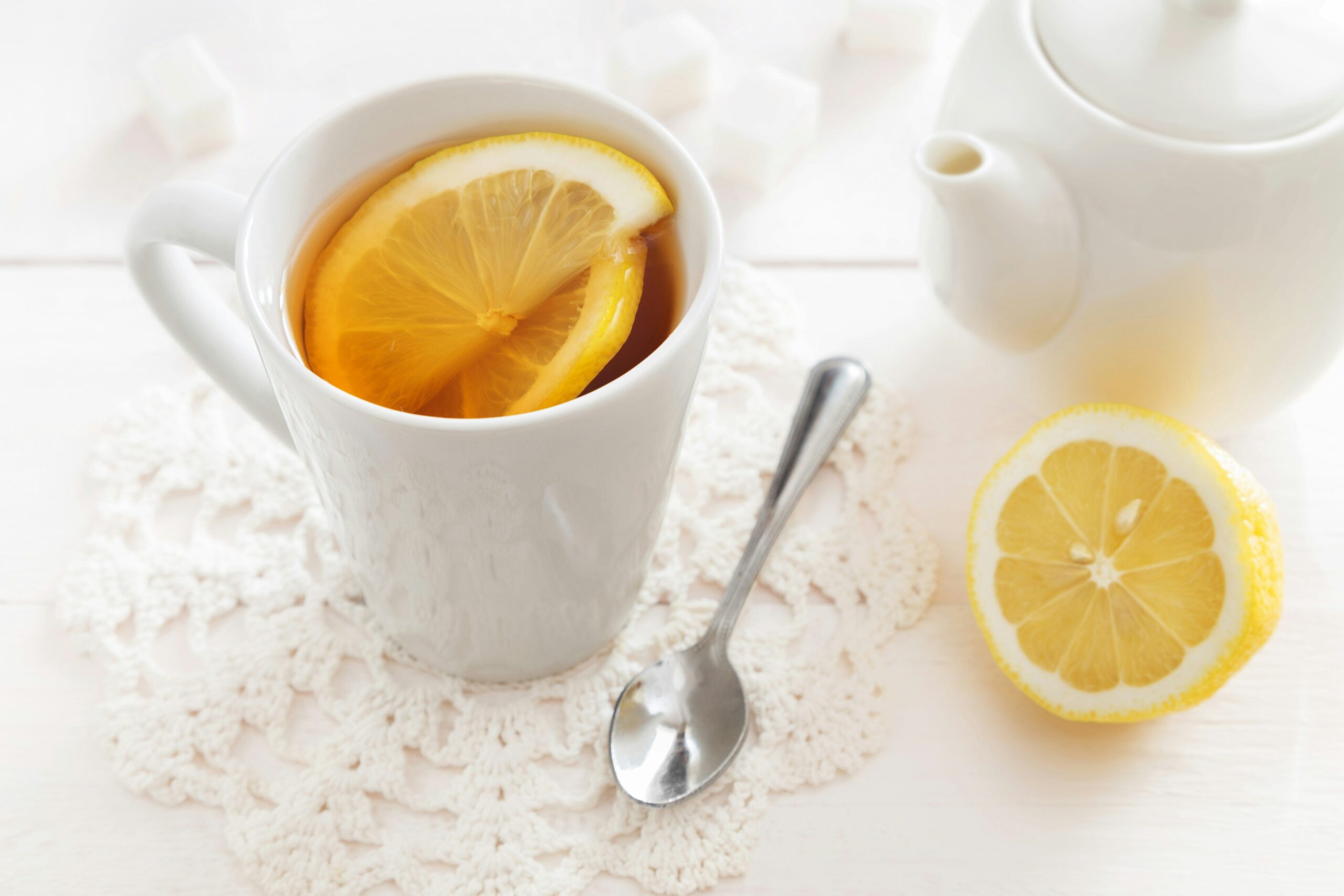 A photo of someone enjoying a cup of lemon balm tea with a peaceful expression