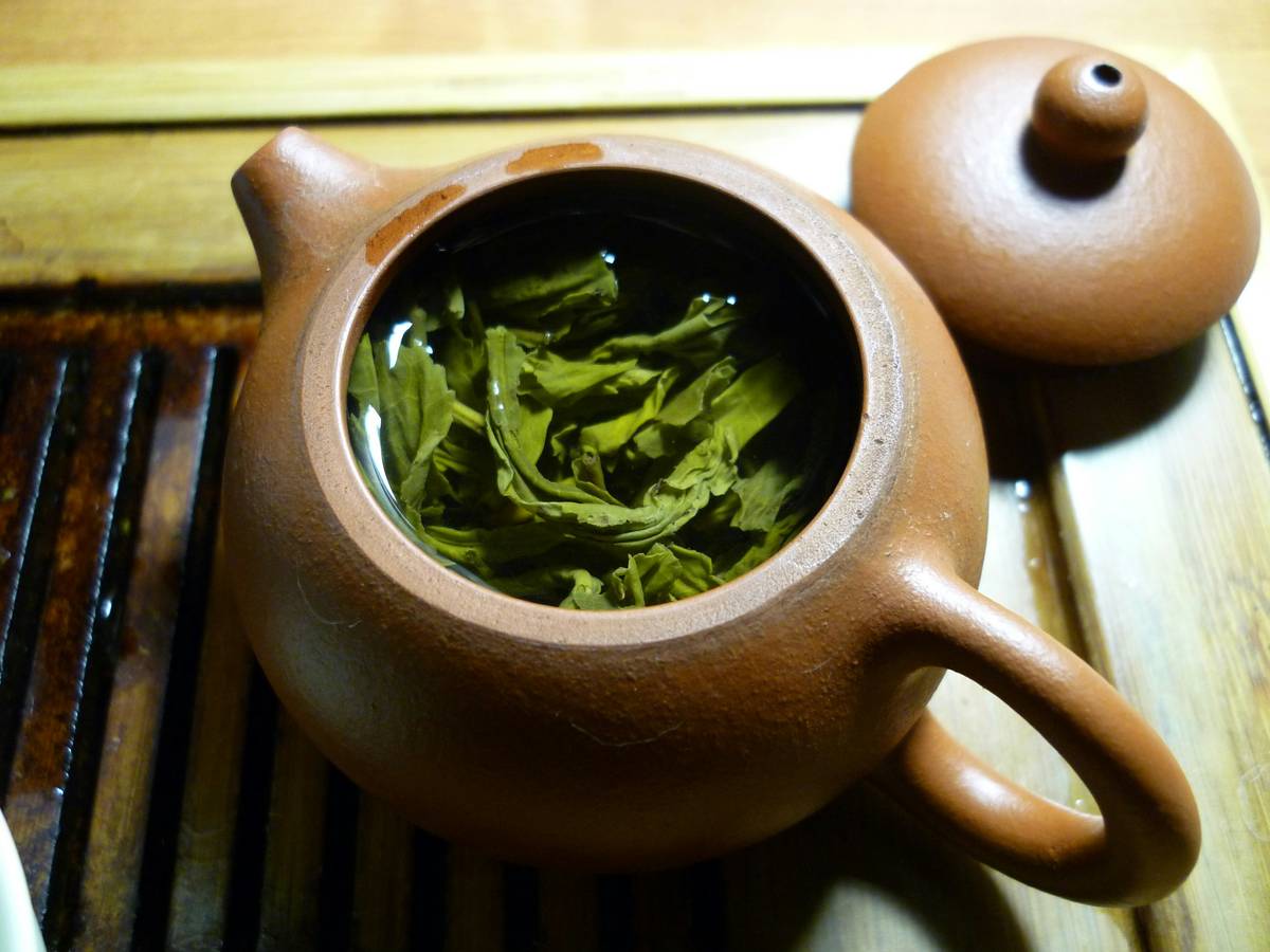 Photo of steeped lemon balm tea with honey in a glass mug
