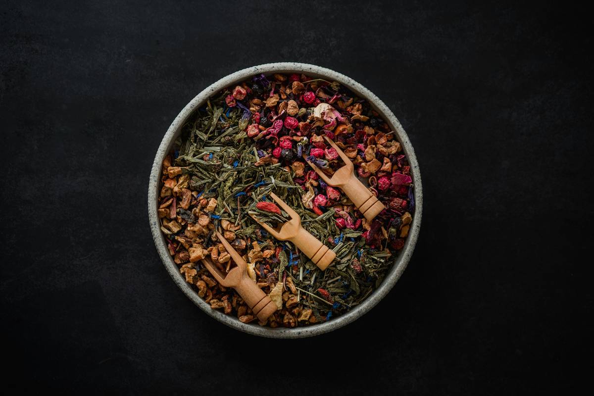 A steaming cup of lemon balm tea on a wooden table